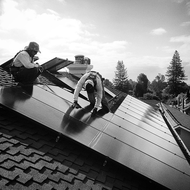 Photo of two Allterra Employee's installing Solar Panels.